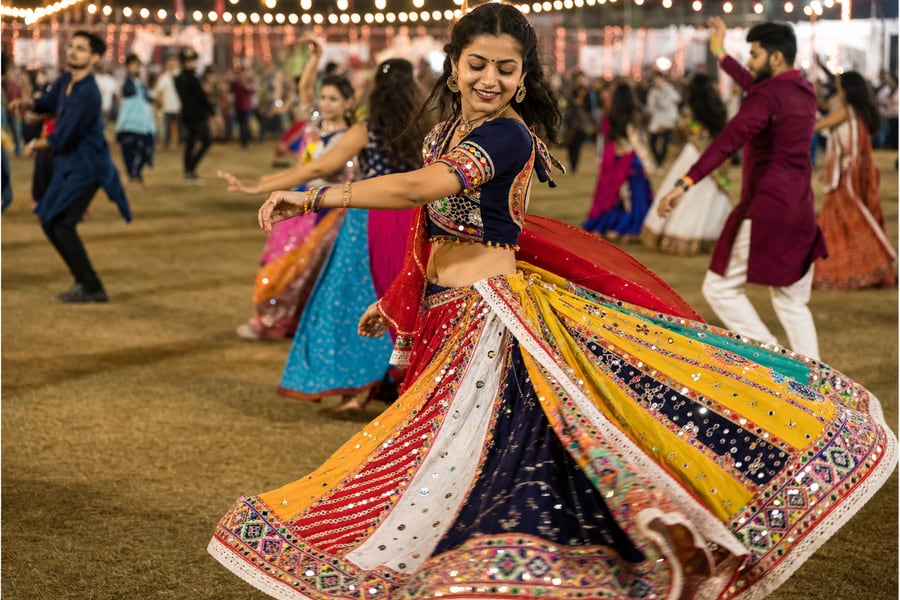 A dancer in motion during Garba, showing the flared skirt and embroidered fabric