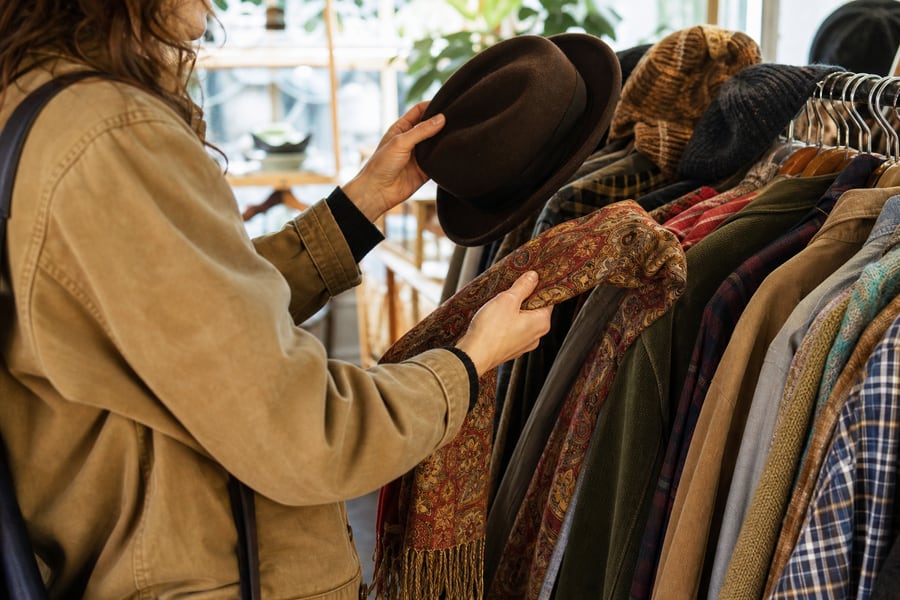 Browsing hats and scarves in a thrift store